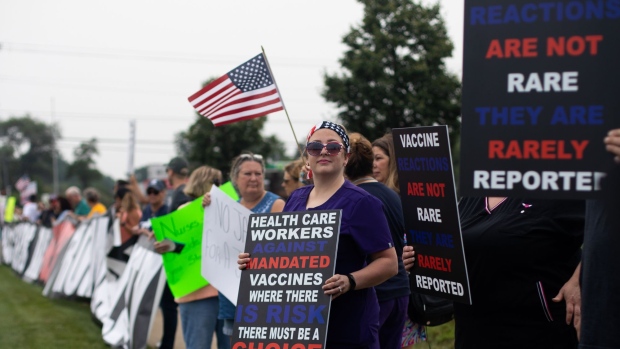 Demonstrators during a protest against mandatory Covid-19 vaccinations for healthcare workers in Michigan. Photographer: Emily Elconin/Bloomberg