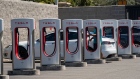 Tesla vehicles at charging stations.