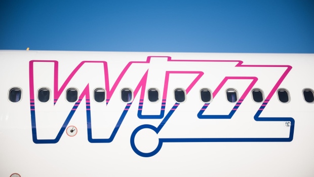 A logo sits on the body of an Airbus A321-231 passenger aircraft, operated by Wizz Air Holdings Plc, at Liszt Ferenc airport in Budapest, Hungary, on Monday, Jan. 9, 2017. Wizz Air, the No. 1 no-frills carrier in Eastern Europe, grew passenger numbers 19 percent to 23 million as it added more destinations in the west of the continent. Photographer: Akos Stiller/Bloomberg