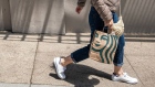 A pedestrian carries a Starbucks branded shopping bag in San Francisco, California, U.S., on Thursday, July 22, 2021. Starbucks Corp. is expected to release earnings figures on July 27. Photographer: David Paul Morris/Bloomberg