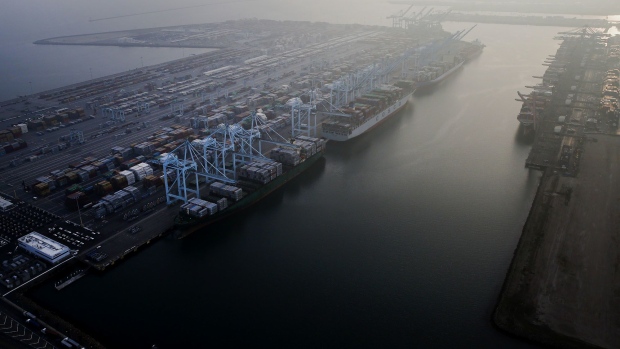 Ships carrying cargo containers are docked in in this aerial photograph taken above the Port Of Los Angeles in Los Angeles, California.
