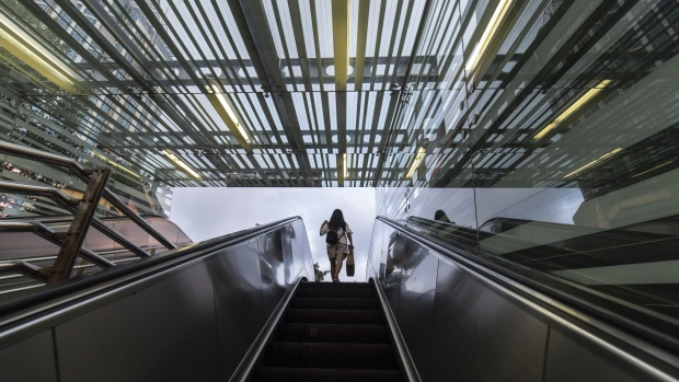 A pedestrian uses an escalator in Shanghai, China, on Tuesday, July 20, 2021. Banks in China kept the benchmark loan rate unchanged, indicating that the central bank is continuing to keep policy stable despite a recent surprise move to add liquidity to the financial system. Photographer: Qilai Shen/Bloomberg