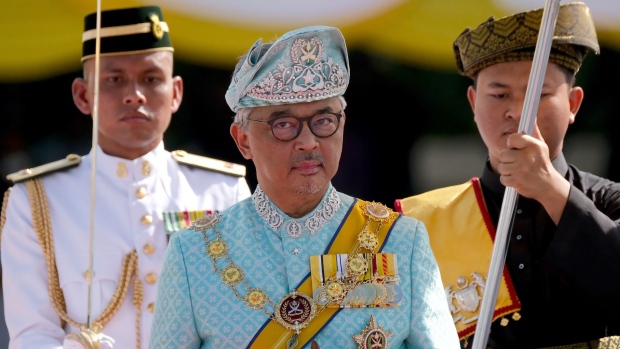 Sultan Abdullah Sultan Ahmad, Malaysia's king, center, onserves an honor guard during a ceremony at Parliament Square in Kuala Lumpur, Malaysia, on Thursday, Jan. 31, 2019. Malaysia has crowned a new king in a traditional ceremony, after the previous monarch stepped down midway through his term in an unprecedented abdication.