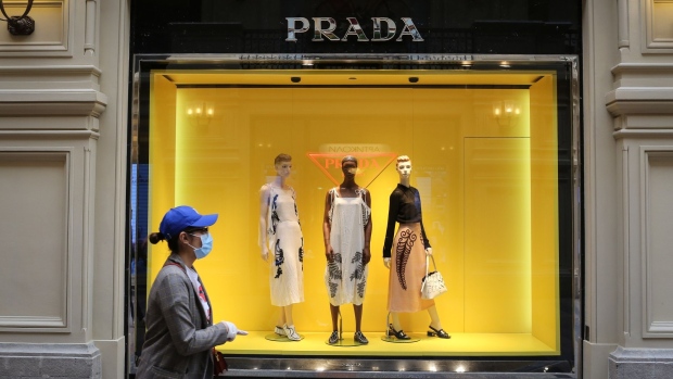 A pedestrian wearing a protective mask is reflected in the window of a Prada SpA store on Rodeo Drive in Beverly Hills, California, U.S., on Tuesday, May 19, 2020.