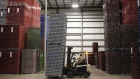 An employee uses a forklift to move pallets of aluminum cans inside the warehouse. Photographer: Luke Sharrett/Bloomberg
