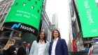 Baiju Bhatt and Vlad Tenev pose in Times Square on Robinhood Markets IPO Listing Day on July 29, 2021 in New York City.