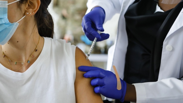 A healthcare administers a dose of the Pfizer-BioNTech Covid-19 vaccine at a vaccination center at the Miami Dade College North Campus in North Miami, Florida.