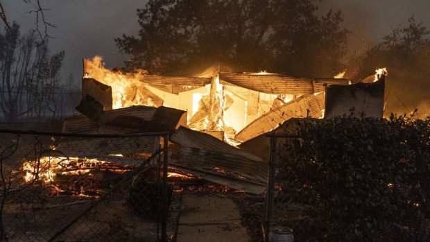 A burning property is seen during the Zogg fire near the town of Ono in Shasta County, California, U.S., on Sunday, Sept. 27, 2020. In Shasta County, the new, fast-spreading Zogg fire burned 7,000 acres by Sunday evening, prompting evacuations, according to the San Francisco Chronicle.
