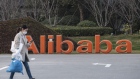 A pedestrian passes a logo outside the Alibaba Group Holding Ltd. headquarters in Hangzhou, China, on Wednesday, Jan. 20, 2021. Alibaba Co-Founder Jack Ma resurfaced for the first time since China’s government began clamping down on his business empire nearly three months ago, appearing in a live-streamed video that sent Alibaba's stock soaring but left plenty of unanswered questions about the billionaire’s fate. Photographer: Qilai Shen/Bloomberg