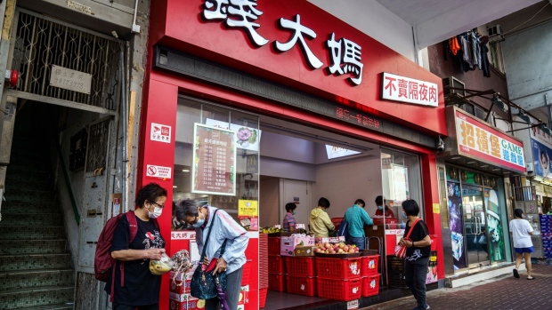 Pedestrians walk past a Qiandama store in Hong Kong, China, on Thursday, April 1, 2021. Chinese fresh food chain operator Qiandama is considering an initial public offering in Hong Kong as soon as this year, according to people familiar with the matter.