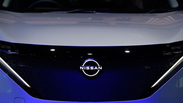 A Nissan Motor Co. badge is displayed on an Ariya crossover electric sport utility vehicle (SUV) outside the company's headquarters in Yokohama, Japan, on Tuesday, July 28, 2020. Nissan is struggling to restore profitability and sales after the November 2018 arrest of its former Chairman Carlos Ghosn and because a lack of new models left it ill-prepared to face a downturn in global vehicle demand amid the coronavirus pandemic. Photographer: Akio Kon/Bloomberg