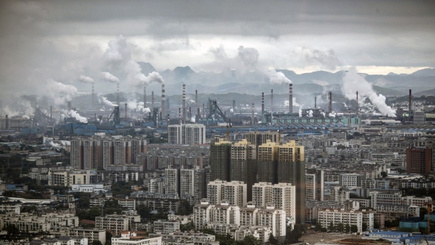 Smoke and exhaust rise from a large industrial complex surrounding Liuzhou Iron & Steel Co.'s facility in Liuzhou, China, on Monday, May 17, 2021. Liuzhou has used test drives, free parking and abundant charging points to get people to embrace EVs. Photographer: Qilai Shen/Bloomberg