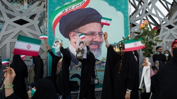 Supporters hold photographs of Ebrahim Raisi, Iran's president, as they celebrate his presidential election win in Imam Hossein Square in Tehran, Iran, on Saturday, June 19, 2021. Voters overwhelmingly picked Raisi on Friday, albeit on a low turnout.