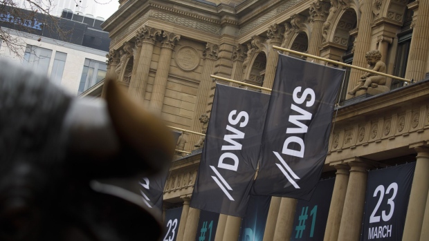 DWS Group logos sit on banners hanging outside the Frankfurt Stock Exchange, operated by Deutsche Boerse AG, as Deutsche Bank AG make an initial public offering (IPO) of shares for its asset-management division in Frankfurt, Germany, on Friday, March 23, 2018. DWS held its ground on the first day of trading after parent Deutsche Bank raised about 1.4 billion euros ($1.7 billion) from an initial public offering. Photographer: Alex Kraus/Bloomberg