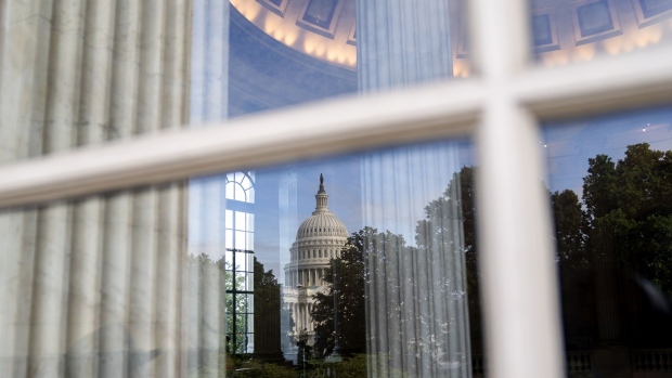 The U.S. Capitol is reflected in a window of the Russell Senate Office building in Washington, D.C., U.S., on Friday, June 25, 2021. The White House scored a political win by sealing a $579 billion infrastructure deal with a group of Democratic and Republican senators, yet the bipartisan plan faces hurdles in Congress that reflect challenges to his broader economic agenda. Photographer: Stefani Reynolds/Bloomberg