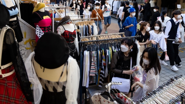 Shoppers wearing protective masks look at clothing at the Hongdae shopping district in Seoul, South Korea, on Saturday, May 22, 2021. South Korea is scheduled to release consumer confidence figures on May 25. Photographer: SeongJoon Cho/Bloomberg