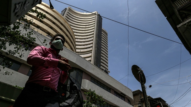 A pedestrian walks past the Bombay Stock Exchange (BSE) building in Mumbai, India, on Wednesday, May 26, 2021. Money managers are counting on a consumption-led economic rebound from the world's worst coronavirus outbreak and the nation's long-term growth prospects to support corporate earnings and equity valuations. Photographer: Dhiraj Singh/Bloomberg
