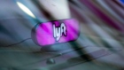 A Lyft Inc. light sits on the dashboard of a vehicle in the Time Square neighborhood of New York, U.S., on Wednesday, May 8, 2019. Simmering tensions between drivers and ride-hailing companies are flaring again, as drivers in major cities across the U.S. and the U.K. went on strike Wednesday over low wages and unstable working conditions.