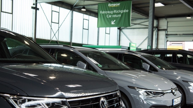 A Volkswagen AG (VW) Tiguan SUV, left, and a VW Golf automobile in a Europcar Mobility Group automobile rental depot in Hamburg, Germany, on Tuesday, June 29, 2021. Volkswagen AG confirmed it’s considering an acquisition of a majority stake in Europcar to expand its offerings of mobility services. Photographer: Stefanie Loos/Bloomberg