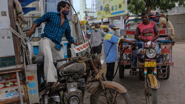 Refueling vehicles at a Bharat Petroleum Ltd. gas station in Jamnagar, Gujarat, India, on Saturday, July 31, 2021. Indian pump prices are in uncharted territory as ever-increasing government levies coincide with crude’s recovery from the depths of the Covid-19 pandemic.