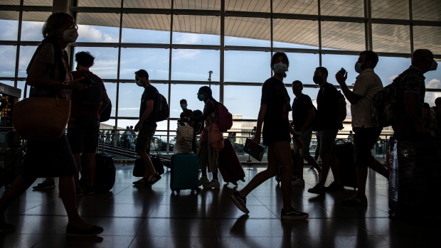 Passengers in the departures hall in El Prat airport, operated by Aena SA, in Barcelona, Spain, on Monday, Aug. 2, 2021. Nations like the U.S. and Spain have followed up their swift inoculation campaigns with a corresponding uptick in air travel. Photographer: Angel Garcia/Bloomberg