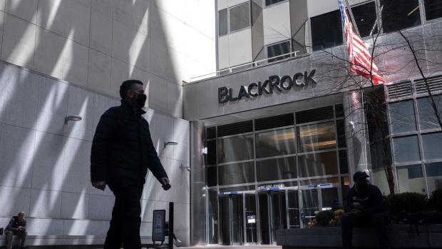 A pedestrian wearing a protective mask passes in front of BlackRock Inc. headquarters in New York, U.S, on Tuesday, April 13, 2021. BlackRock Inc. is scheduled to release earnings figures on April 15. Photographer: Jeenah Moon/Bloomberg