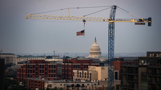 A construction crane in front of the U.S. Capitol in Washington, D.C., U.S., on Monday, Aug. 2, 2021. The U.S. Senate is heading toward passage this week of a $550 billion infrastructure bill that would provide the biggest infusion of federal spending on public works in decades and mark a major milestone for President Joe Biden’s economic agenda. Photographer: Al Drago/Bloomberg