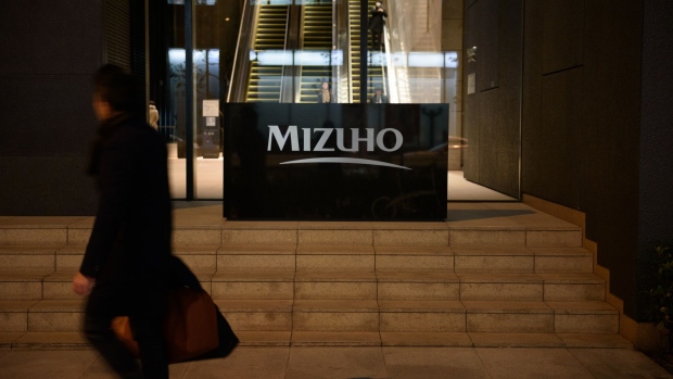 A pedestrian walks past the Mizuho Financial Group Inc. headquarters in Tokyo, Japan, on Tuesday, Jan. 29, 2019. Mizuho is scheduled to release earnings figures on Jan. 31. Photographer: Akio Kon/Bloomberg