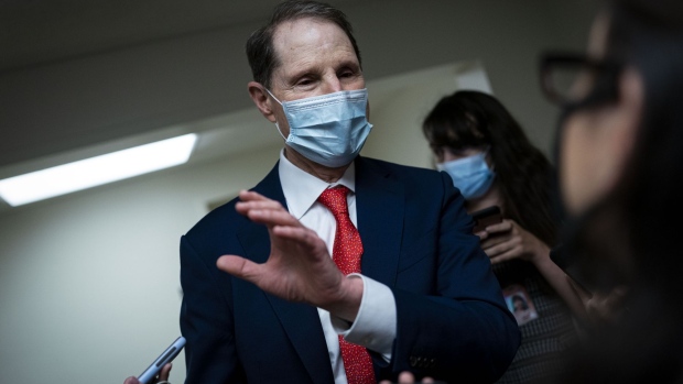 Senator Ron Wyden, a Democrat from Oregon, speaks to members of the media while arriving for a vote in the basement of the U.S. Capitol in Washington, D.C., U.S., on Tuesday, Aug. 3, 2021. The Senate majority leader's plan to pass a $550 billion infrastructure bill this week hit a potential obstacle from a surprising source when a key Republican announced he tested positive for Covid-19 and would quarantine for 10 days. Photographer: Al Drago/Bloomberg