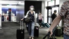 A traveler wearing a protective mask and face shield walks into Terminal 2 at Los Angeles International Airport (LAX) in Los Angeles, California, U.S., on Thursday, Aug. 13, 2020. Airline passenger numbers in the U.S. totaled 559,420 on Aug. 11, compared with 2.31 million the same weekday a year earlier, according to the Transportation Security Administration. Photographer: Bing Guan/Bloomberg