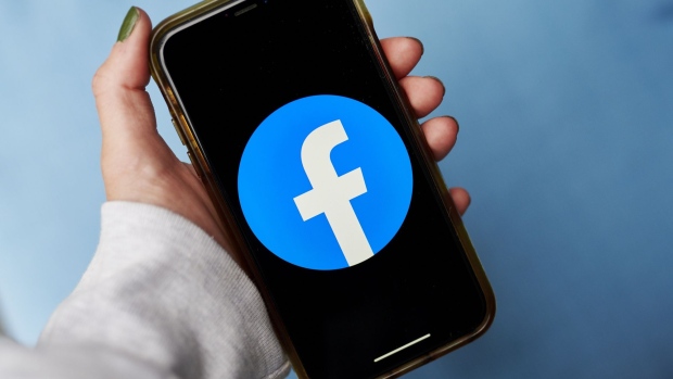 The logo for Facebook is displayed on a smartphone in an arranged photograph taken in Little Falls, New Jersey, U.S., on Wednesday, Oct. 7, 2020. Facebook Inc. is tightening its rules on content concerning the U.S. presidential election next month, including instituting a temporary ban on political ads when voting ends, as it braces for a contentious night that may not end with a definitive winner. Photographer: Gabby Jones/Bloomberg
