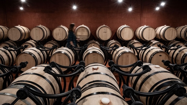 Wine barrels sit in the cellars of Chateau La Dominique vineyard and winery in Pomerol, France, on Monday, Sept. 23, 2019. The U.S. is moving ahead with an investigation into a new French digital tax that could lead to import tariffs on French wine and other goods, despite hopes raised at August's G-7 summit. Photographer: Balint Porneczi/Bloomberg