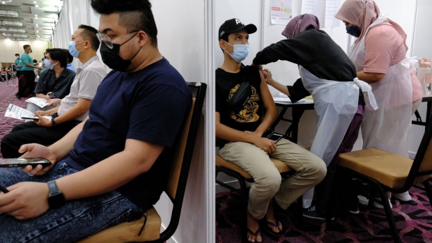 A health worker administers a dose of the Astrazeneca Plc Covid-19 vaccine at a special vaccination center (PPV) set up at the Ideal Convention Centre (IDCC) in Shah Alam, Selangor, Malaysia, on Tuesday, May 25, 2021. Malaysia’s government resisted imposing a full lockdown to avoid derailing a nascent recovery in the economy but has shortened business working hours and cut public transport capacity to reduce movement, while allowing factories and other businesses to operate.