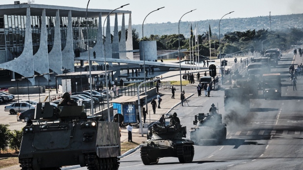 An armored vehicle drives past the Planalto Palace during a military parade in Brasilia, Brazil, on Tuesday, Aug. 10, 2021. Brazil's military staged an unusual convoy of troops and armored vehicles through the capital on Tuesday — an event announced only a day before and that coincided with a scheduled vote in Congress on one of President Jair Bolsonaro's key proposals, reported the Associated Press.