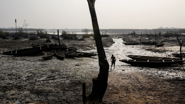 Abandoned fishing boats sit on the ground as crude oil pollution covers the shoreline of an estuary in B-Dere, Ogoni, Nigeria, on Saturday, Feb. 1, 2020. Nigerians from the delta are now asking British judges to allow them to sue Royal Dutch Shell Plc in London over the environmental damage caused by oil spills. Photographer: George Osodi/Bloomberg