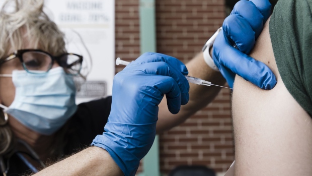 A healthcare worker administers a dose of the Pfizer-BioNTech Covid-19 vaccine at a pop up vaccination site at Hammons Field in Springfield, Missouri, U.S., on Tuesday, Aug. 3, 2021. Some of the most vaccine-resistant parts of the U.S. are now leading the country in the number of people getting a first dose of vaccine, a Bloomberg analysis shows, as surging infections and rising hospitalizations push formerly reluctant Americans to protect themselves. Photographer: Angus Mordant/Bloomberg