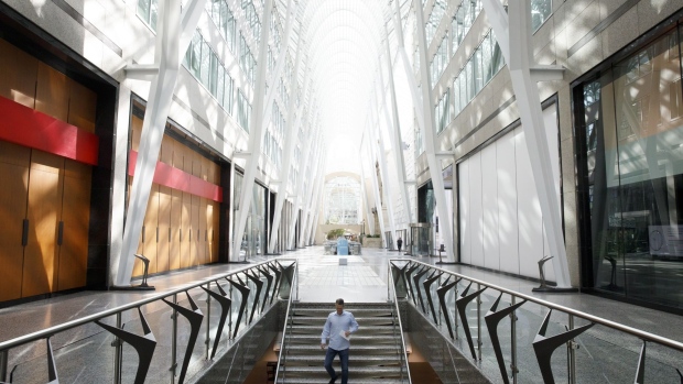 A pedestrian walks down stairs at Brookfield Place in the financial district of Toronto, Ontario, Canada, on Friday, May 22, 2020. Whether the PATH, a subterranean network that provides connections between major commuter stations, over 80 properties, including the headquarters of Canada's five largest banks, and 1,200 retail spots, can return to its glory days will depend initially on how quickly Bay St. firms return workers to their offices.