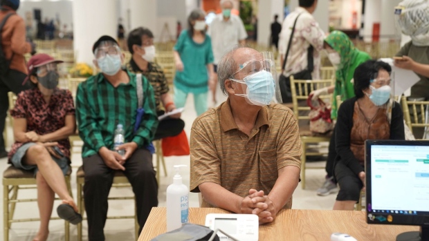 Elderly people get their health being checked ahead of a vaccination at the Lippo Mall Puri shopping mall in Jakarta, Indonesia, on Tuesday, March 9, 2021. Indonesia will expand movement restrictions to three provinces starting next week due to an increase in positive cases. Photographer: Dimas Ardian/Bloomberg