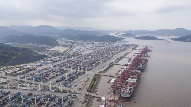 Containers sit stacked next to gantry cranes in this aerial photograph taken above the Port of Ningbo-Zhoushan in Ningbo, China, on Wednesday, Oct. 31, 2018. President Donald Trump wants to reach an agreement on trade with Chinese President Xi Jinping at the Group of 20 nations summit in Argentina later this month and has asked key U.S. officials to begin drafting potential terms, according to four people familiar with the matter. Photographer: Qilai Shen/Bloomberg
