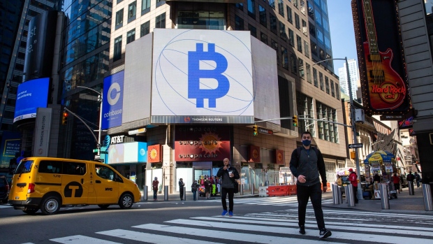 Monitors display Coinbase and Bitcoin signage during the company's initial public offering (IPO) at the Nasdaq MarketSite in New York, U.S., on Wednesday, April 14, 2021. Coinbase Global Inc., the largest U.S. cryptocurrency exchange, is set to debut on Wednesday through a direct listing, an alternative to a traditional initial public offering that has only been deployed a handful of times. Photographer: Michael Nagle/Bloomberg