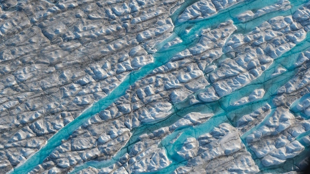 ILULISSAT, GREENLAND - AUGUST 04: In this view from an airplane rivers of meltwater carve into the Greenland ice sheet near Sermeq Avangnardleq glacier on August 04, 2019 near Ilulissat, Greenland. The Sahara heat wave that recently sent temperatures to record levels in parts of Europe has also reached Greenland. Climate change is having a profound effect in Greenland, where over the last several decades summers have become longer and the rate that glaciers and the Greenland ice cap are retreating has accelerated. (Photo by Sean Gallup/Getty Images)