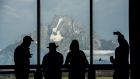 The silhouettes of tourists are seen viewing the Grand Teton mountain range outside of the Jackson Lake Lodge during the Jackson Hole economic symposium, sponsored by the Federal Reserve Bank of Kansas City, in Moran, Wyoming, U.S., on Friday, Aug. 25, 2017. The world's two most powerful central bankers on Friday delivered back-to-back warnings against dismantling tough post-crisis financial rules that the Trump administration blames for stifling U.S. growth.