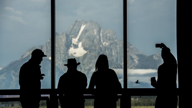 The silhouettes of tourists are seen viewing the Grand Teton mountain range outside of the Jackson Lake Lodge during the Jackson Hole economic symposium, sponsored by the Federal Reserve Bank of Kansas City, in Moran, Wyoming, U.S., on Friday, Aug. 25, 2017. The world's two most powerful central bankers on Friday delivered back-to-back warnings against dismantling tough post-crisis financial rules that the Trump administration blames for stifling U.S. growth.