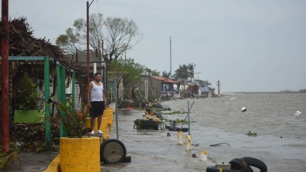 A resident surveys a flooded neighborhood after Hurricane Grace made landfall in Tecolitla, Veracruz state, Mexico, on Saturday, Aug. 21, 2021. Grace has weakened to a Category 1 hurricane after making landfall in Mexico earlier Saturday and is making its way across the center of the country.