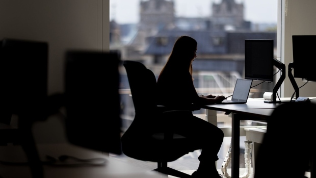 An office worker at a desk in London. Photographer: Jason Alden/Bloomberg