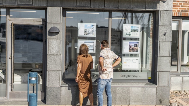 Pedestrians look at property listed in a real estate agent's window in the Eriksberg district of Gothenburg, Sweden, on Saturday, Aug. 24, 2019. The Swedish krona climbed against the dollar for the first time in six days last week after a senior Riksbank official said that inflation outcomes looked "pretty good," fueling expectations of a future rate hike.