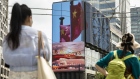 A public screen displays an image of Chinese flags in Shanghai, China, on Wednesday, Aug. 18, 2021. President Xi Jinping said China must pursue "common prosperity," in which wealth is shared by all people, as a key feature of a modern economy, while also curbing financial risks. Photographer: Qilai Shen/Bloomberg