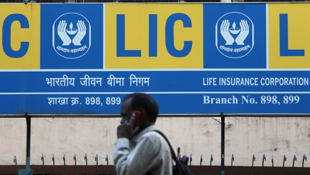 A man talks on a mobile phone outside the Life Insurance Corporation of India (LIC) branch in Mumbai. Photographer: Himanshu Bhatt/NurPhoto via Getty Images