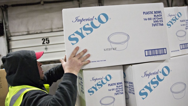 A worker moves a box of Sysc Corp. plastic bowls at the company's distribution facility in Des Plaines, Illinois, U.S., on Tuesday, Jan. 30, 2018. Sysco is scheduled to release earnings figures on February 5. Photographer: Daniel Acker/Bloomberg
