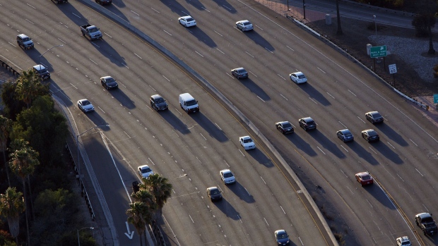 Vehicles move slowly in rush hour traffic on the freeway.